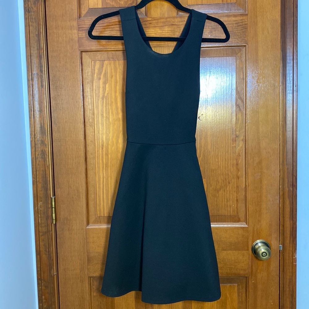 Black A-line dress with crossed straps in back